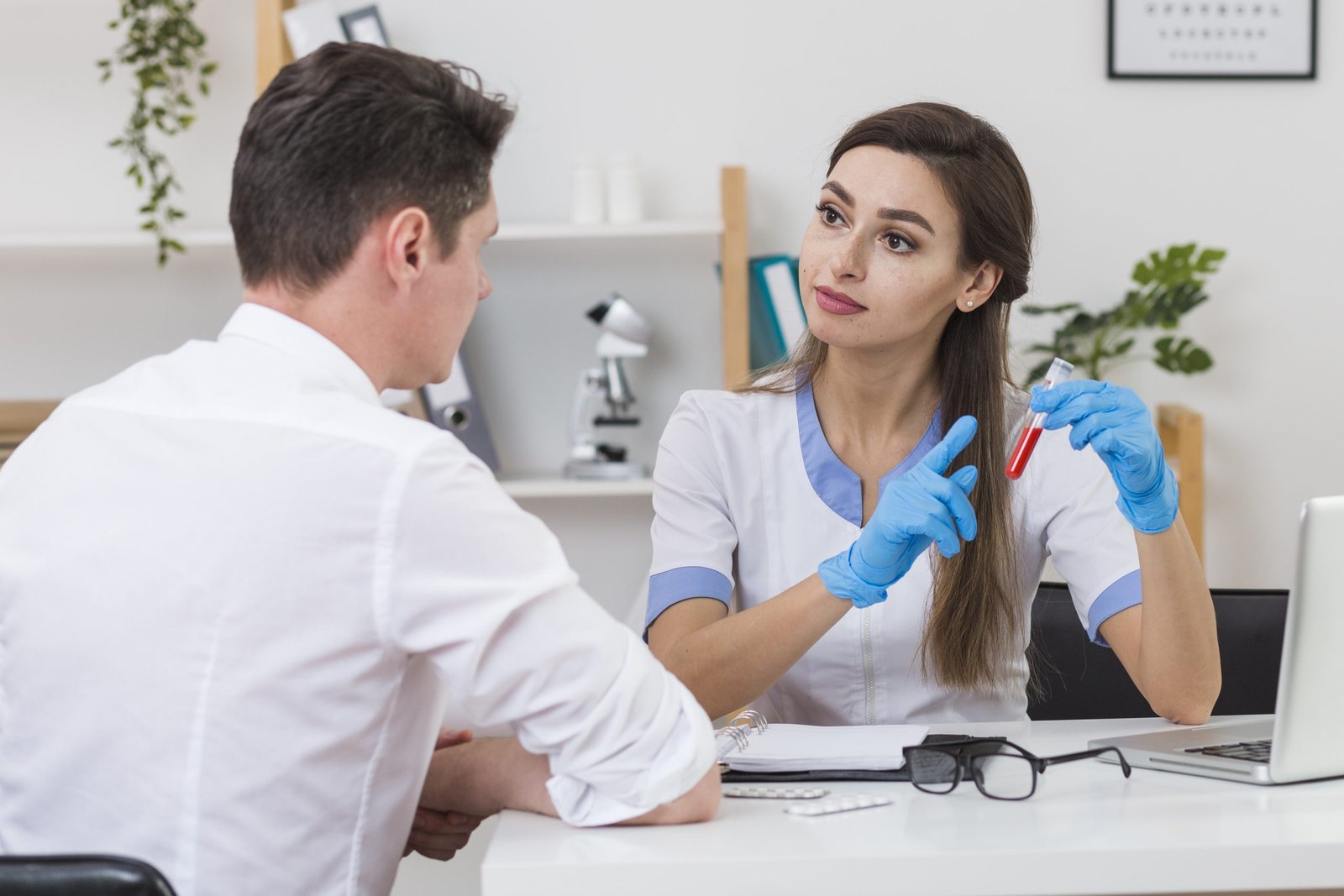 beautiful doctor showing blood sample patient scaled